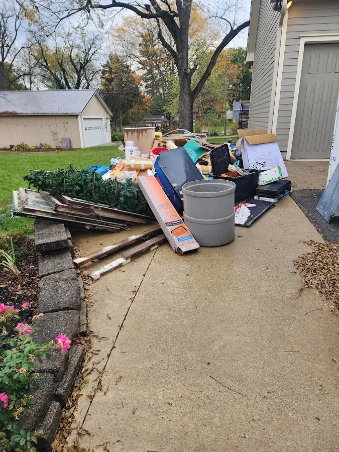 Dumpster being loaded with debris for 12 Yard Dumpster Rental in Desloge